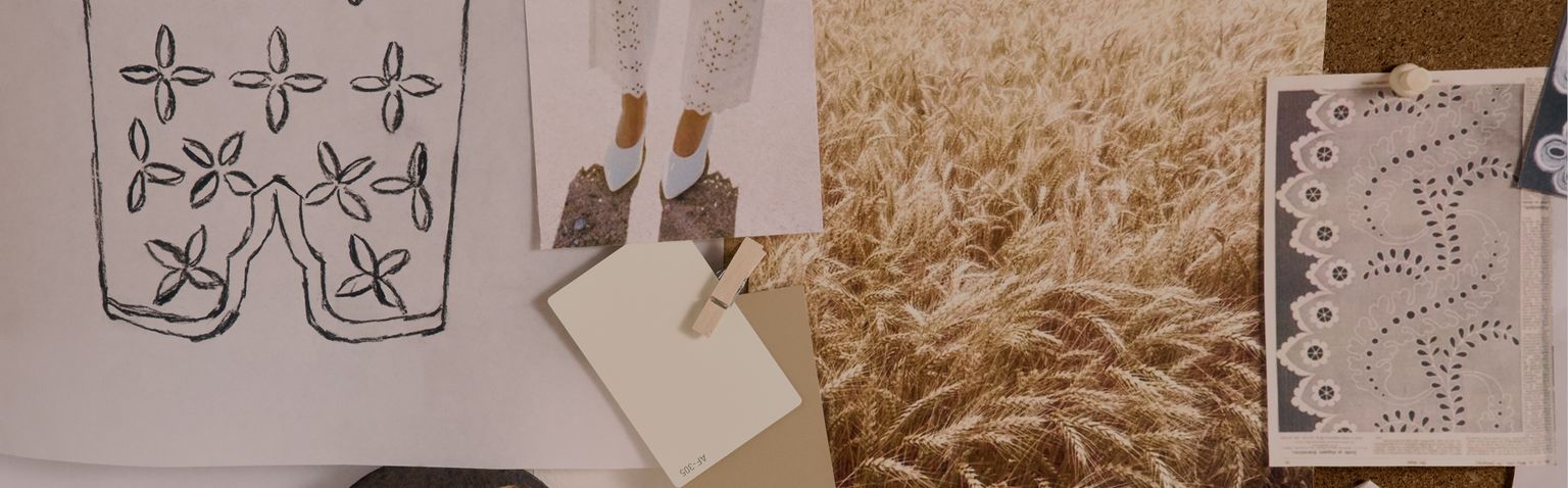 A corkboard displays fabric swatches, a sketch with floral patterns, a photograph of a wheat field, yarn, paint samples, and lace, arranged in an inspiration collage.