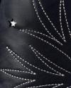 Close-up of dark leather surface with white decorative stitching in a starburst pattern and a small star-shaped cutout.