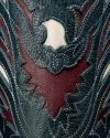 Close-up of detailed stitched leather with intricate patterns in dark green, burgundy, and beige colors.