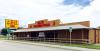Western-style wear store with a wooden exterior and a sign reading "Eli's Western Wear" on the roof. A large billboard with the same name is visible on the side.