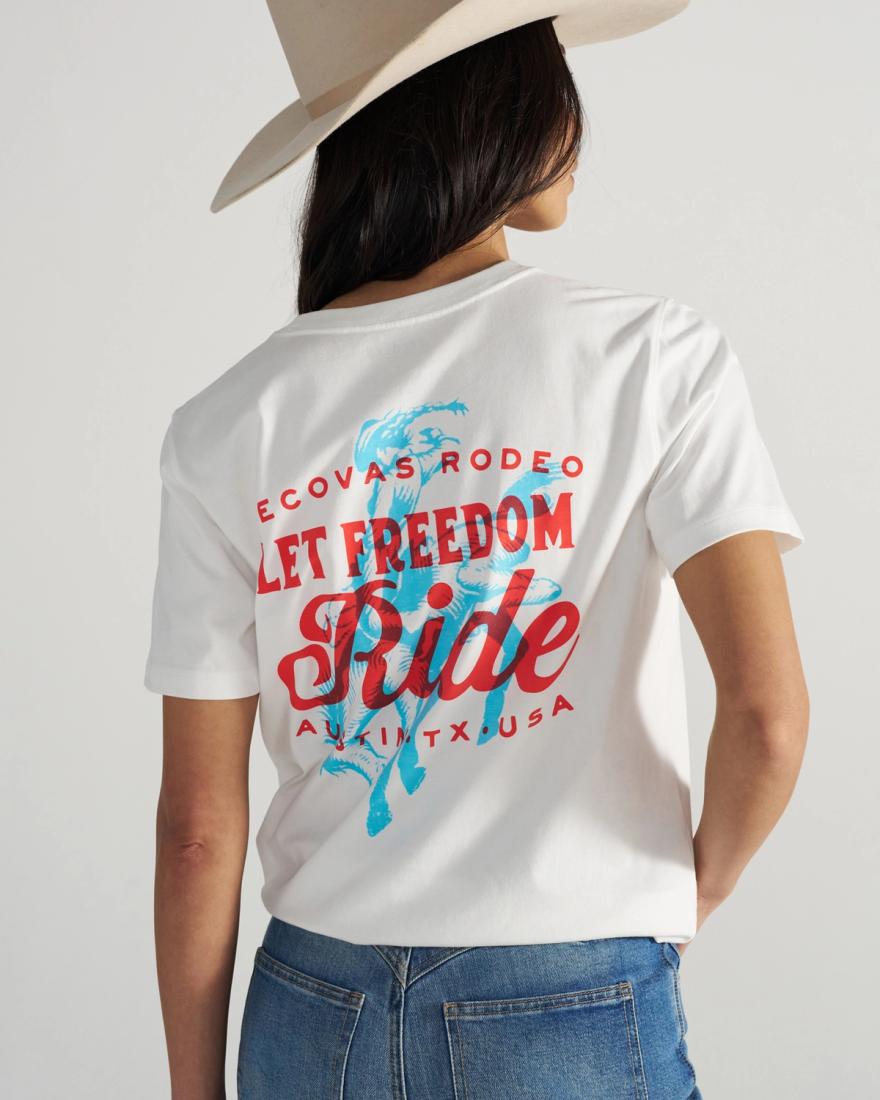 Person wearing a white t-shirt with red and blue text on the back that reads, "Ecovas Rodeo Let Freedom Ride Austin, TX USA," and a cowboy hat.