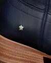 Close-up of a dark blue leather boot with a small metallic star stud and a light brown wooden heel.
