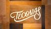 White script logo reading 'Tecovas' displayed on a background of rectangular brown and tan leather panels.