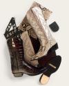 Two pairs of cowboy boots, one brown with a croc pattern and initials “JAM,” one snakeskin, arranged with leather and snakeskin swatches, a monogram set, and a branded sole.