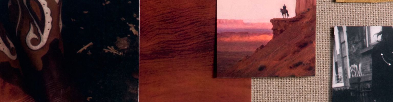 A corkboard displays photos of cowboy boots, a person on a canyon cliff, a black-and-white photo, a metal star badge, and a handwritten note reading "Howdy.