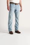 A person wearing light blue jeans, a brown belt, a white shirt, and brown cowboy boots stands against a plain white background.