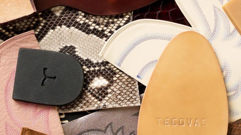 A variety of leather and textile boot parts, including soles, snake skin, and embroidered pieces, are arranged in an overlapping pattern. The word "TECOVAS" is embossed on one leather sole.