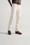 Person wearing off-white jeans, a brown belt, a graphic t-shirt, and brown cowboy boots, standing against a plain light background.