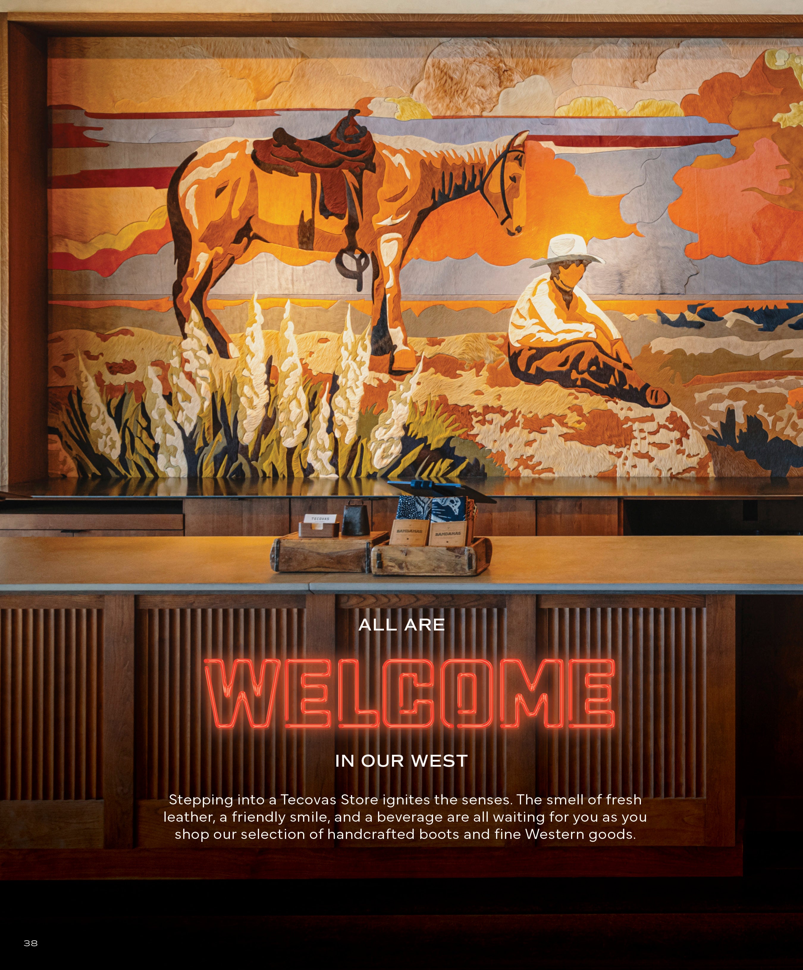Interior of a Tecovas retail store with a sales counter and a large, colorful tapestry-style rug depicting a saddled horse and a cowboy. Neon text reads: ALL ARE WELCOME IN OUR WEST.
