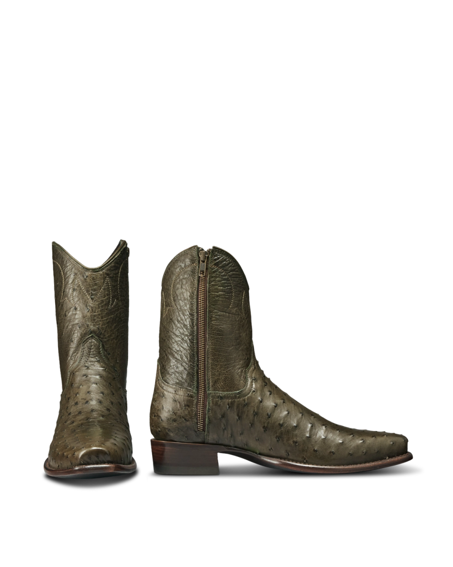 The Jack in Dark Forest Ostrich. A pair of olive green Dark Forest Ostrich leather boots with a side zipper, pointed toes, and low wooden heels, displayed on a white background.