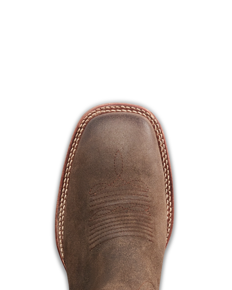 The Doc in Moss Suede. Top view of a brown leather cowboy boot with decorative stitching, white welt stitching around the toe, and subtle accents of rich Moss Suede for added texture.