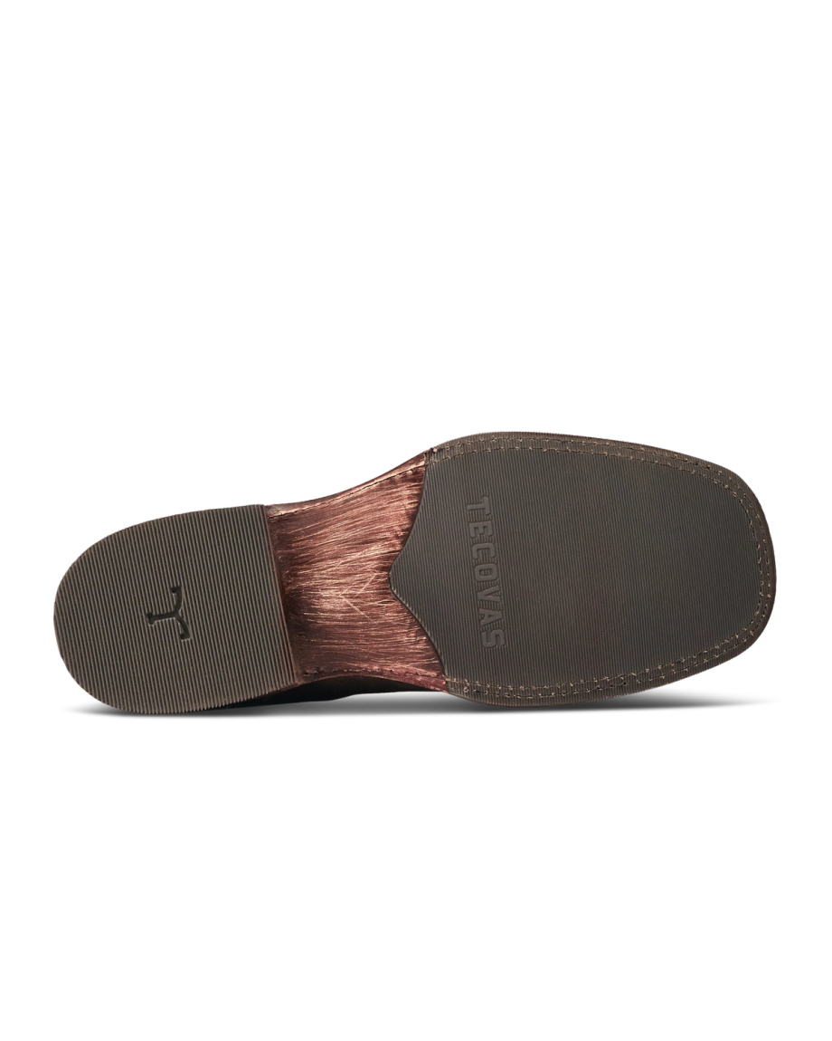 The image shows the bottom view of a brown dress shoe sole with a textured rubber heel and toe, and the word "GEORGES" embossed in the center, reminiscent of refined designs like The Doc Suede or Moss Suede.